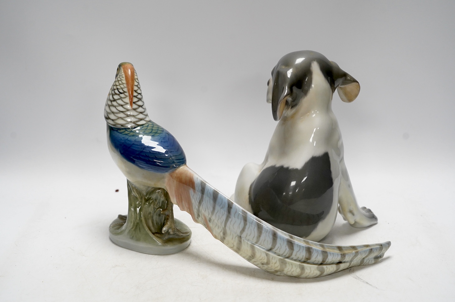 A Royal Copenhagen puppy, 20cm high, and a pheasant. Condition - good
